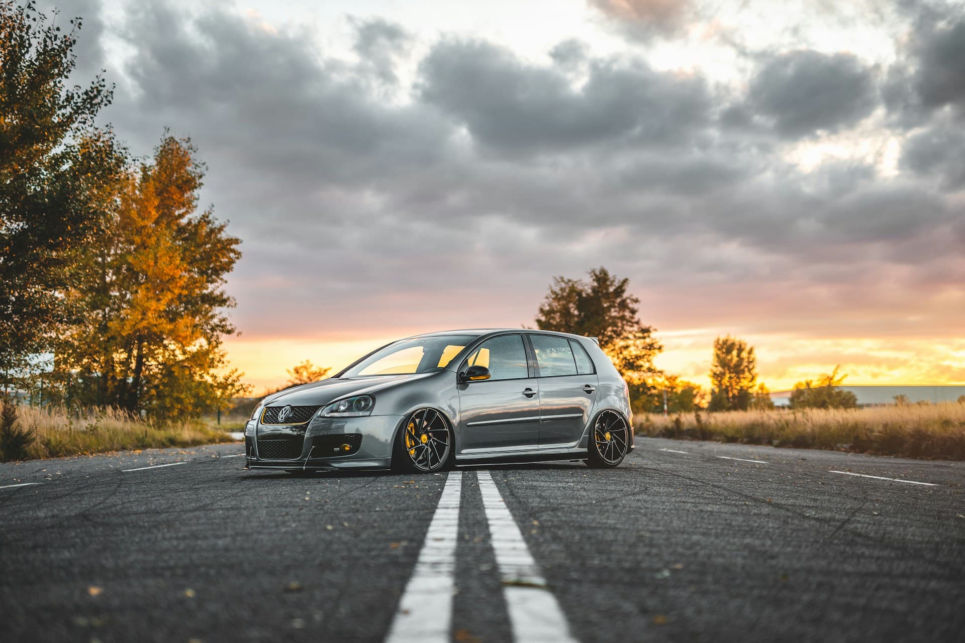 Silver performance hatchback on an empty road